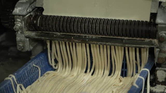 Noodles pulled out of a noodle making machine