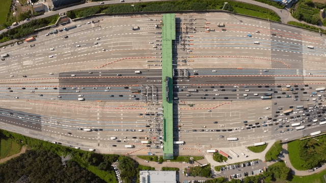 Busy highway tollgate with many vehicles