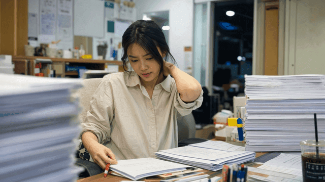 Woman working late at office desk
