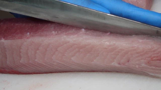 Yellow tail being sliced with precision