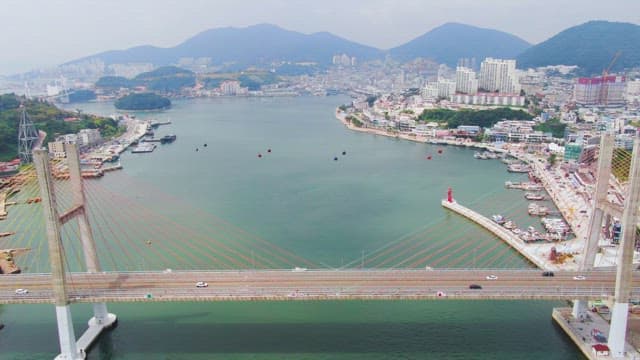 Scenic view of a coastal city with a bridge