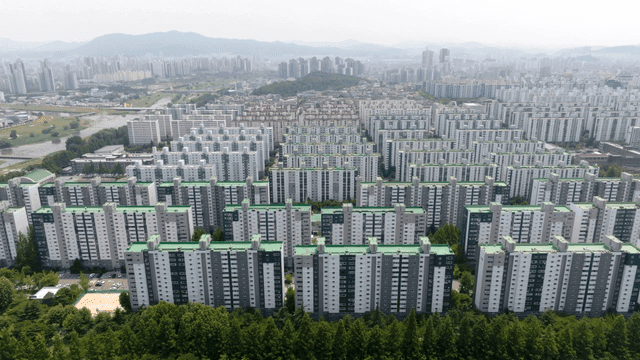 Aerial view of large apartment complex and city landscape