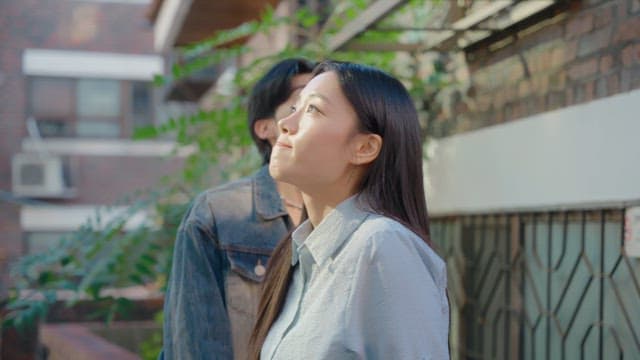 Couple looking up in a sunny alley