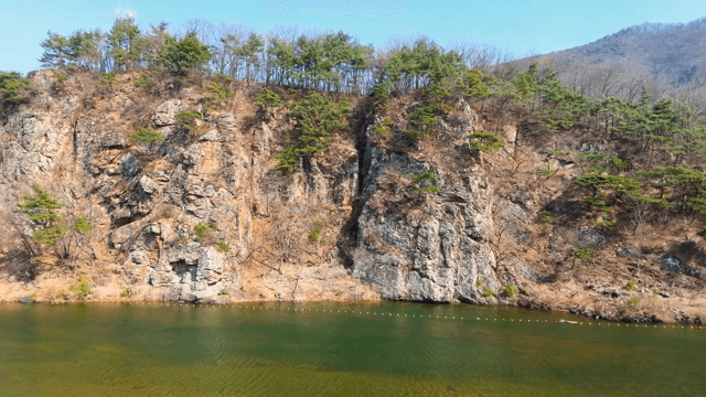 Rocky cliff with a bridge over a river