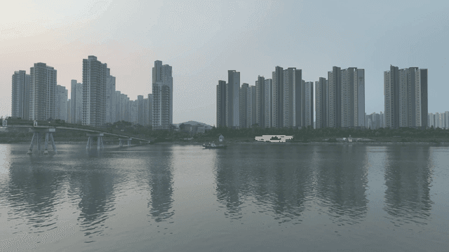 Boats on a river with city skyline