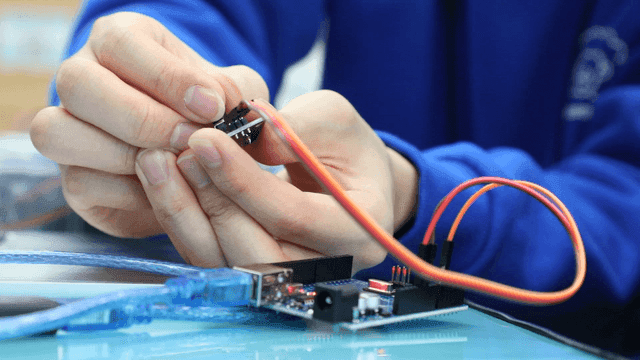 Hands assembling electronic components