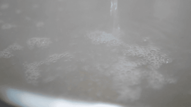 Clear broth poured into pot