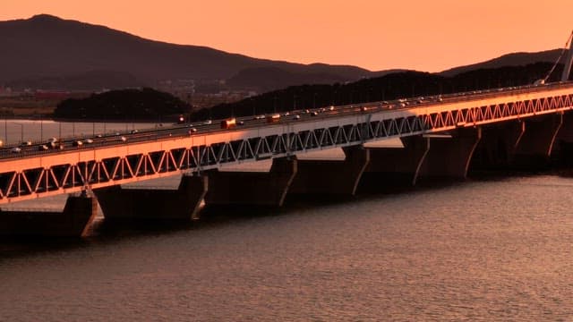 Bridge over water during sunset