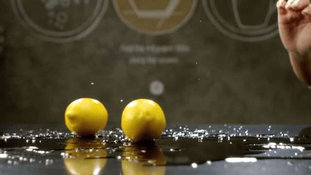 Lemons rolling over a shiny surface