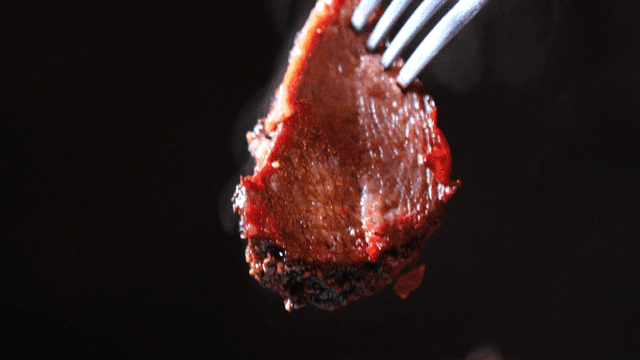 Juicy steak on fork