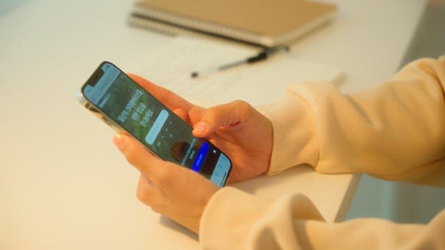 Person Browsing Smartphone Indoors