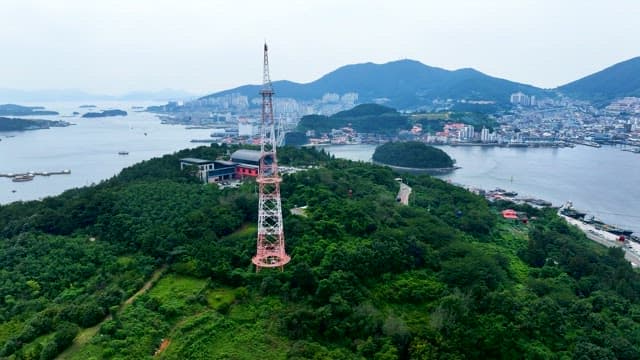 Coastal City with Green Hills and a Bridge