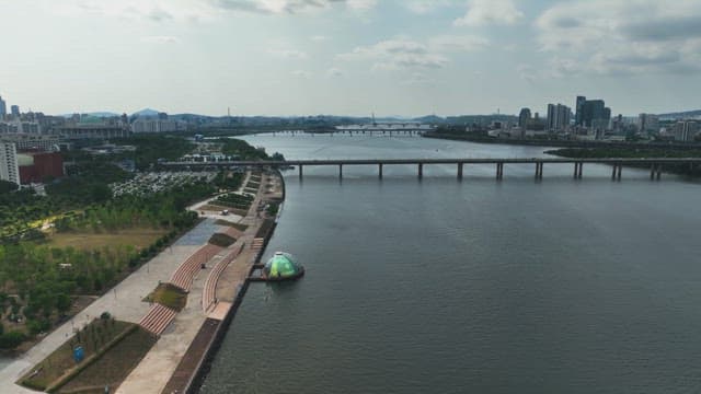 Serene river with a city skyline and park