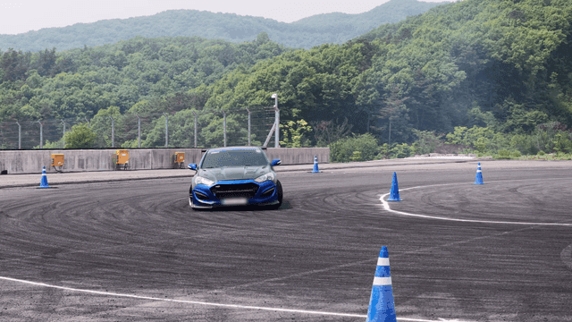 Blue sports car drifting on track