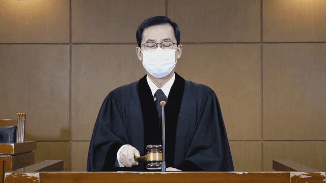 Judge in a courtroom delivering a verdict