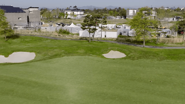 A golf course near urban buildings