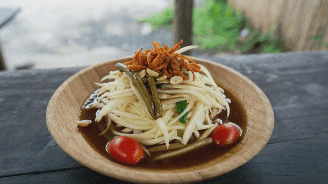 Papaya salad and Som Tum on wooden table