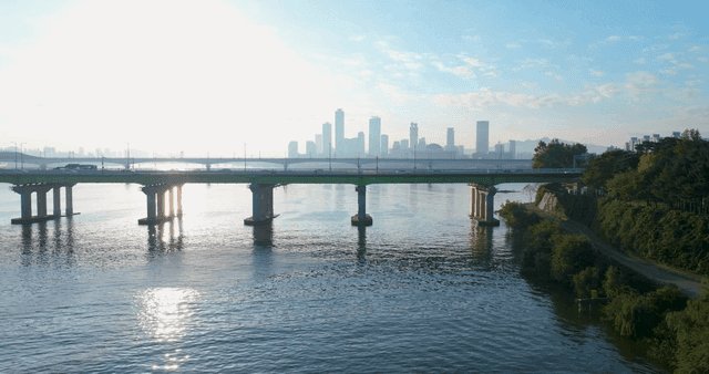 Bridge over river with view of city skyline
