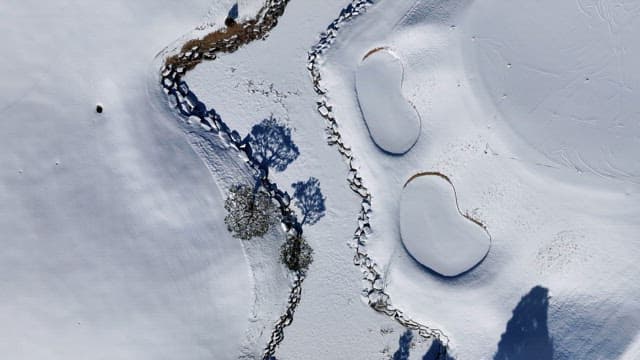 Snow-covered Landscape with Serene Ponds