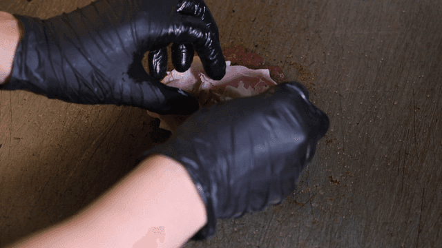 Sliced ham placed on cheese over patty