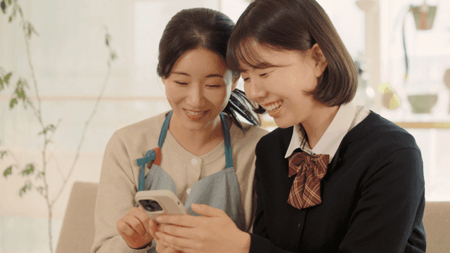 Mother and daughter looking at a phone