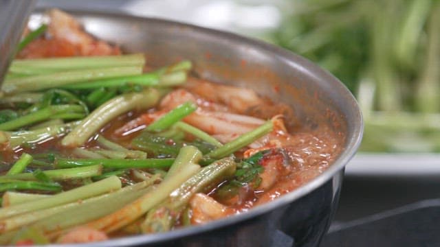 Fresh water parsley in boiling hot pot in a pot