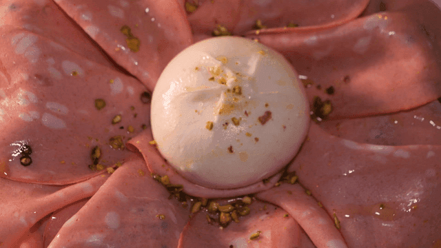 Mortadella pizza topped with meat slices and cheese