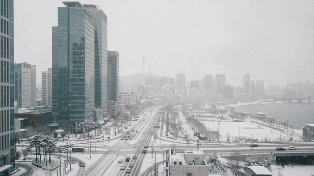 Snow-covered cityscape with tall buildings