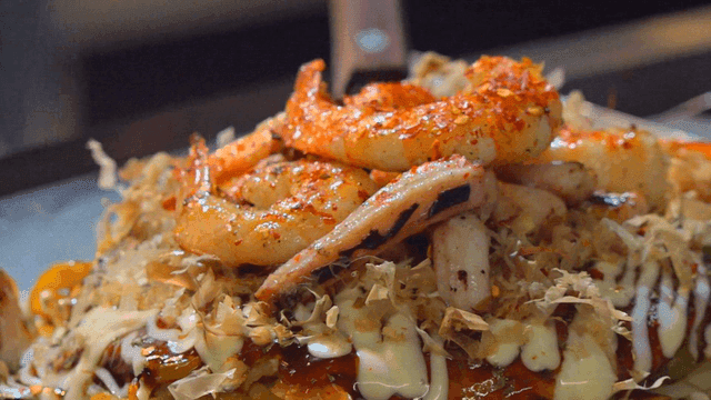 Delicious okonomiyaki with shrimp and sauce