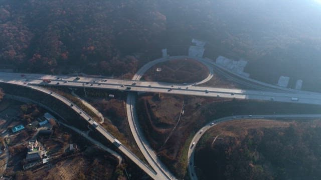 Overhead View of Highway Interchange Under Mountains