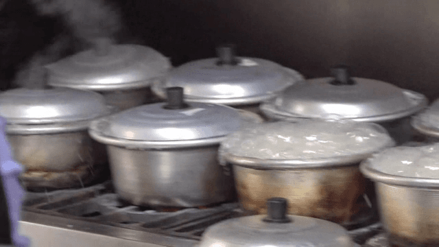 Steaming pots on a stove in a kitchen