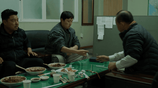 Two men arm wrestling on table