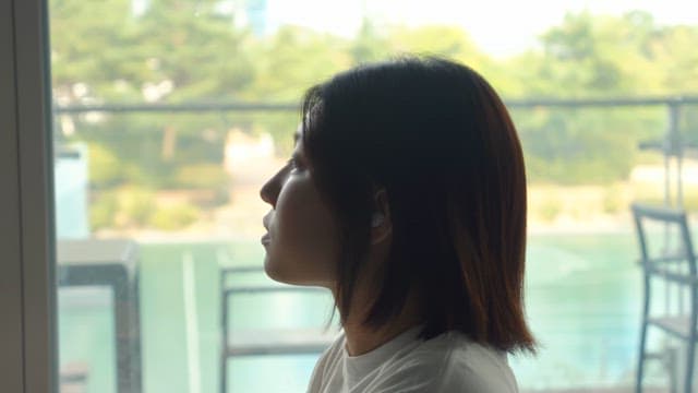 Woman sitting by the window and smiling