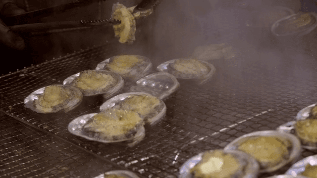 Grilling abalone on a hot grill