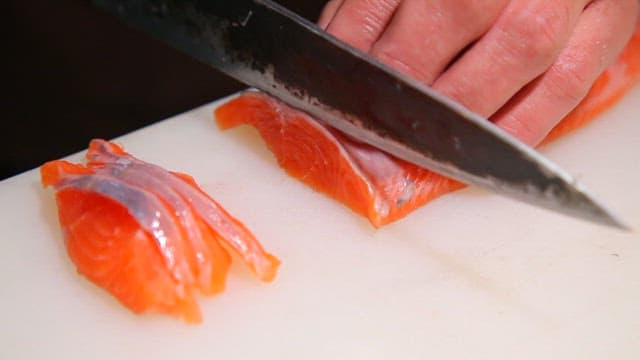 Slicing fresh trout on a cutting board