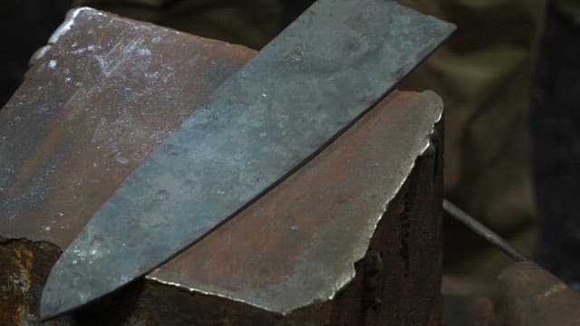 Metal blade being forged on an anvil