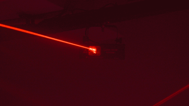 Red vibrant laser beams in dark club