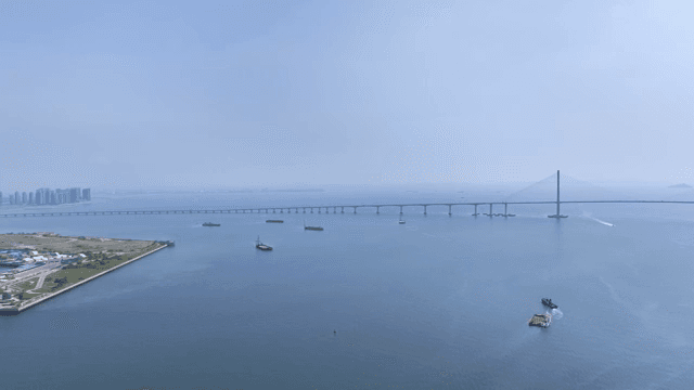 A vast sea with a long bridge and ships