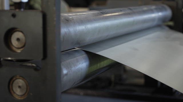 Metal sheet being processed in a factory