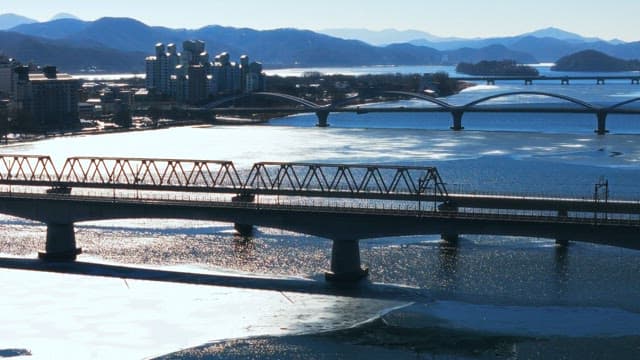 Winter View of a Frozen River and Bridges