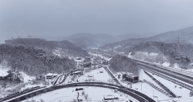 Snow-covered landscape with roads and forest