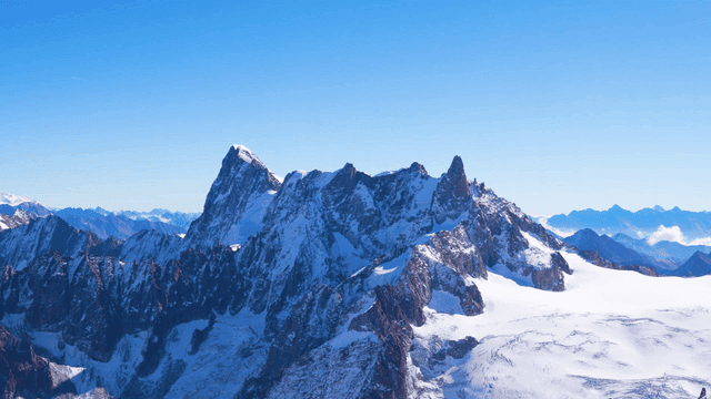Snow-covered mountain peaks under a clear sky