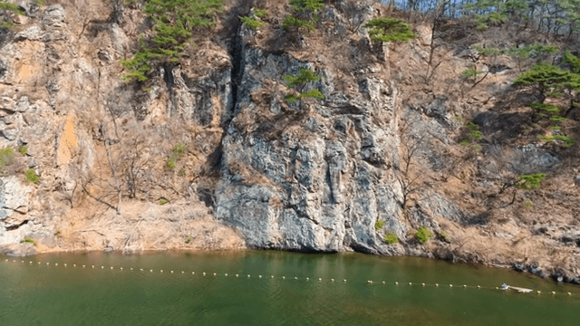 Rocky cliff by a calm river