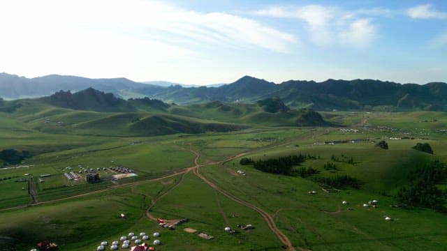 Expansive green hills and distant mountains