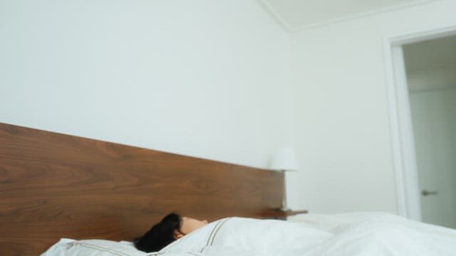 Woman Checking Her Phone After Waking Up