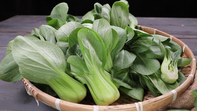 Fresh bok choy arranged in a basket