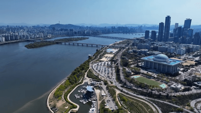 Cityscape along river with cherry blossoms in bloom
