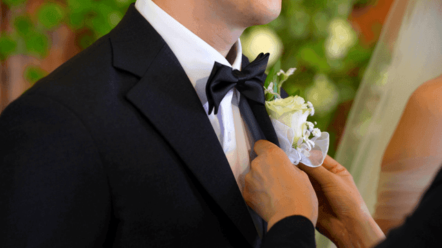 Groom adjusting his flower