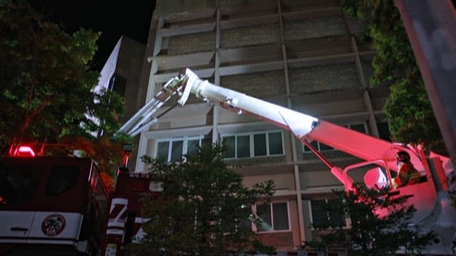 Night Rescue Operation with Crane and Firefighters