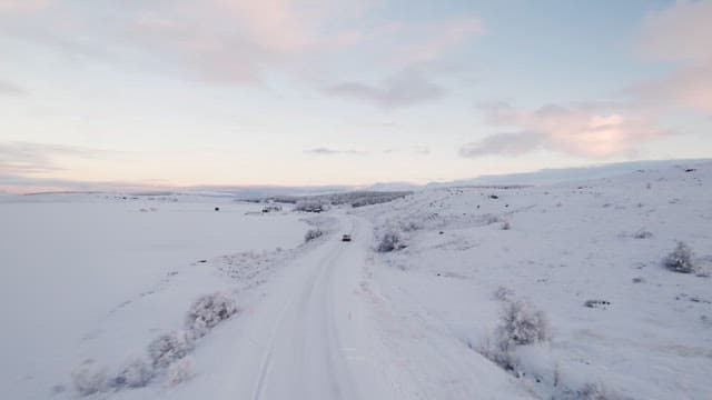 Car driving through a snowy landscape